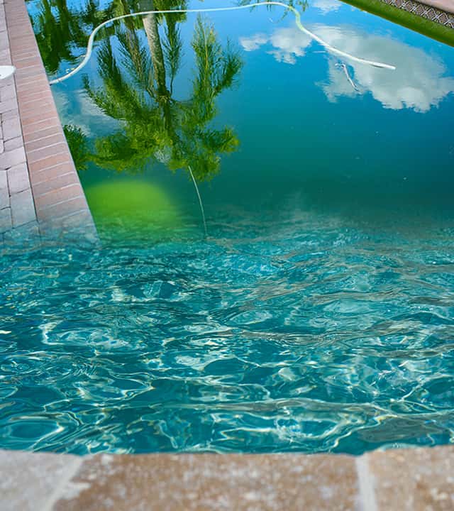 A before after shot of a green pool cleanup job with algae bloom followed by sparkling blue, balanced water.